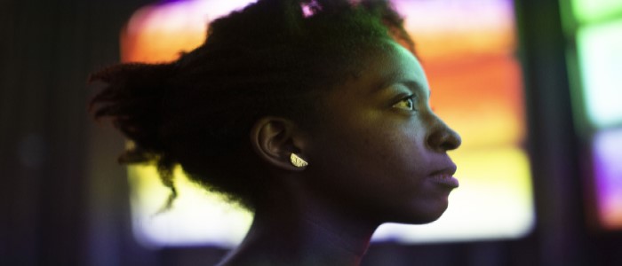 Dreamachine installation showing a woman silhouetted by coloured light. Photo credit Urszula Soltys